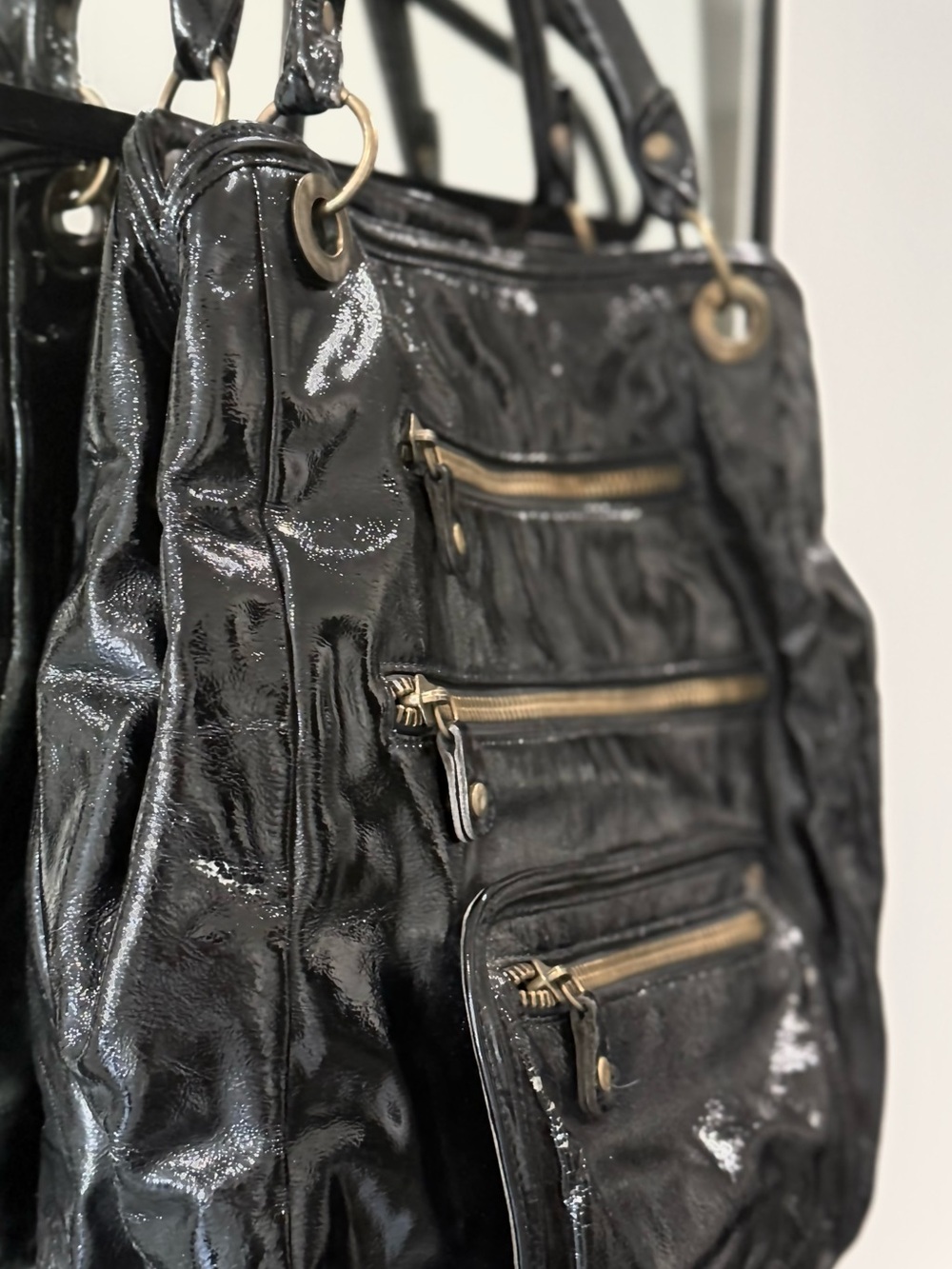 Sleek Black Patent Shoulder Bag with Gold Accents